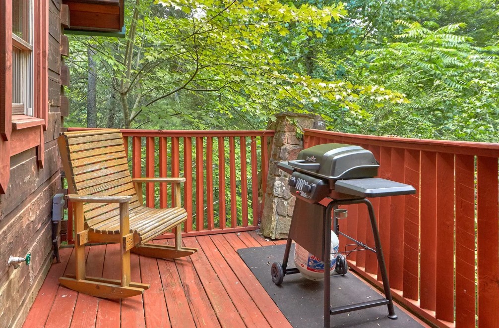 balcony with a rocking chair and a grill