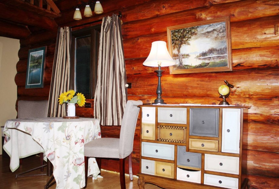 dining room with a round table and a cabinet with mismatches drawers