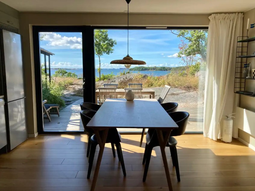 dining room with a dining table and modern black chair with a beautiful view of the ocean