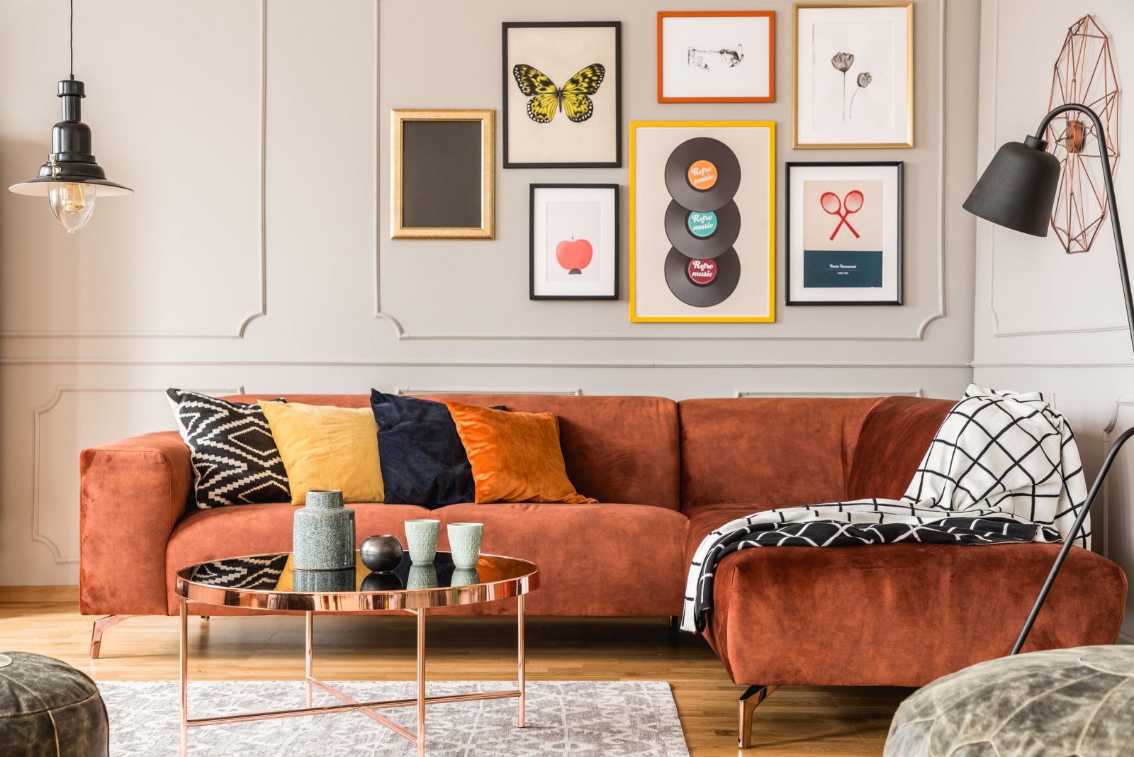 living room with an l-shaped couch, round table, a lot of photos on the gallery wall