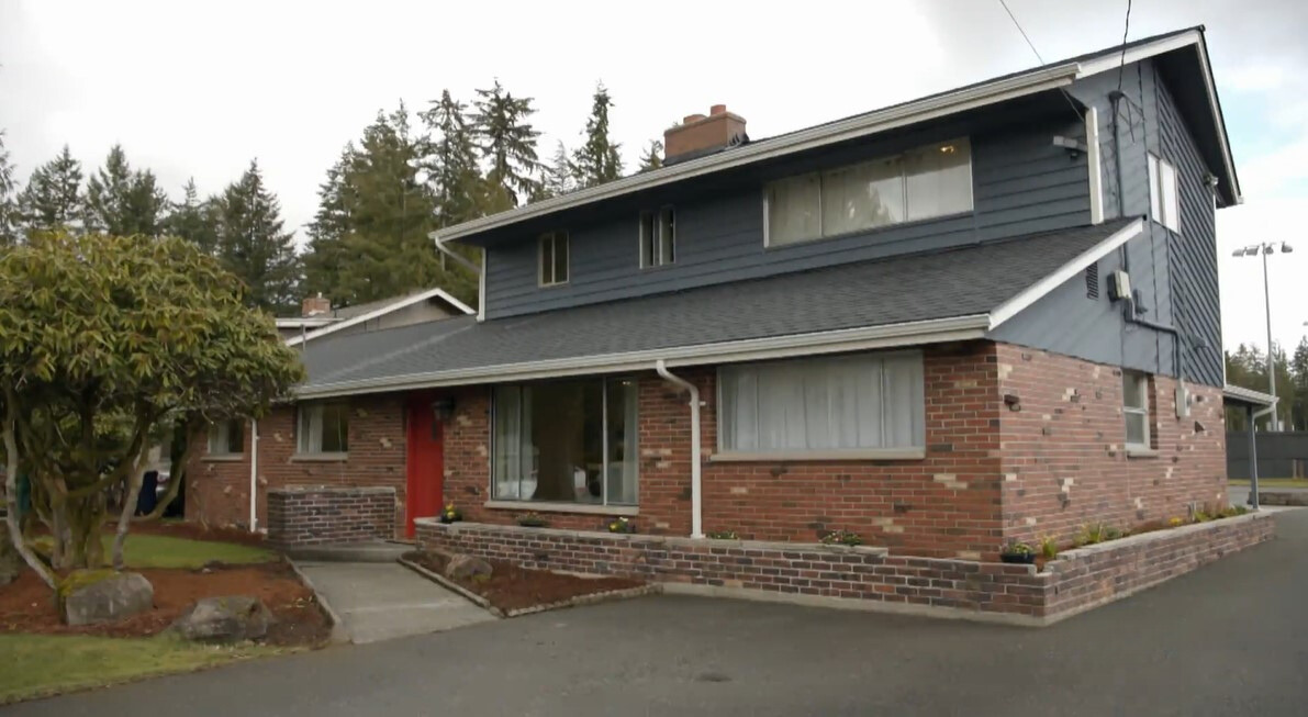 exterior of a home that's half red bricks and half pale blue