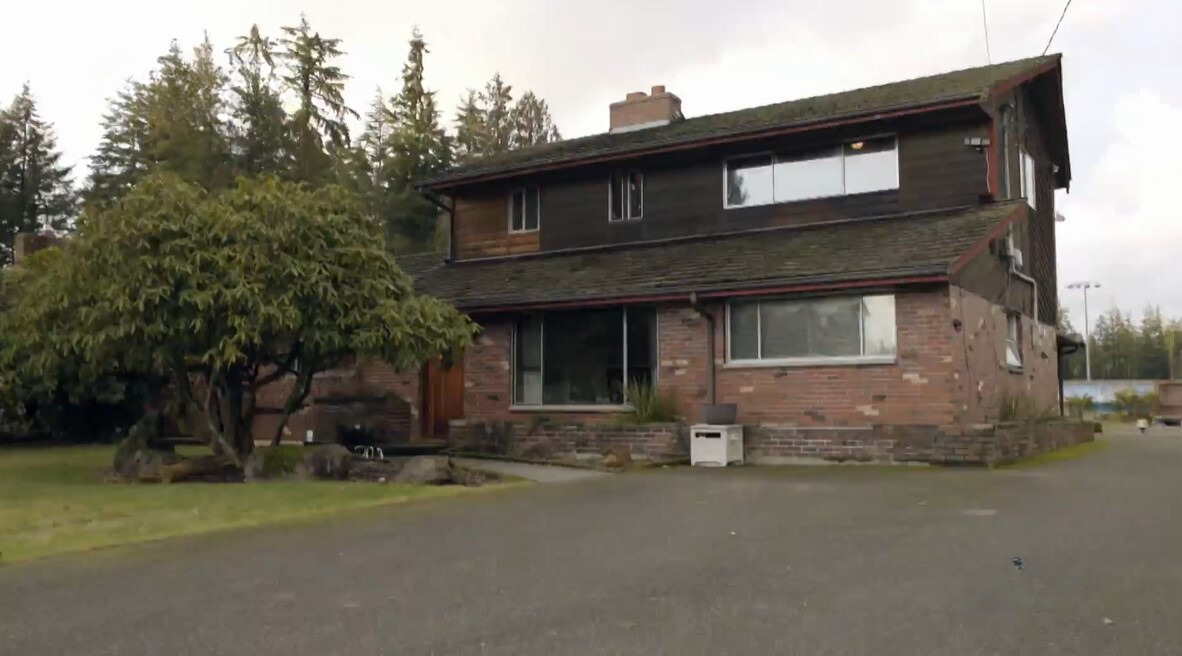 exterior of a home that's half red bricks and half dark brown