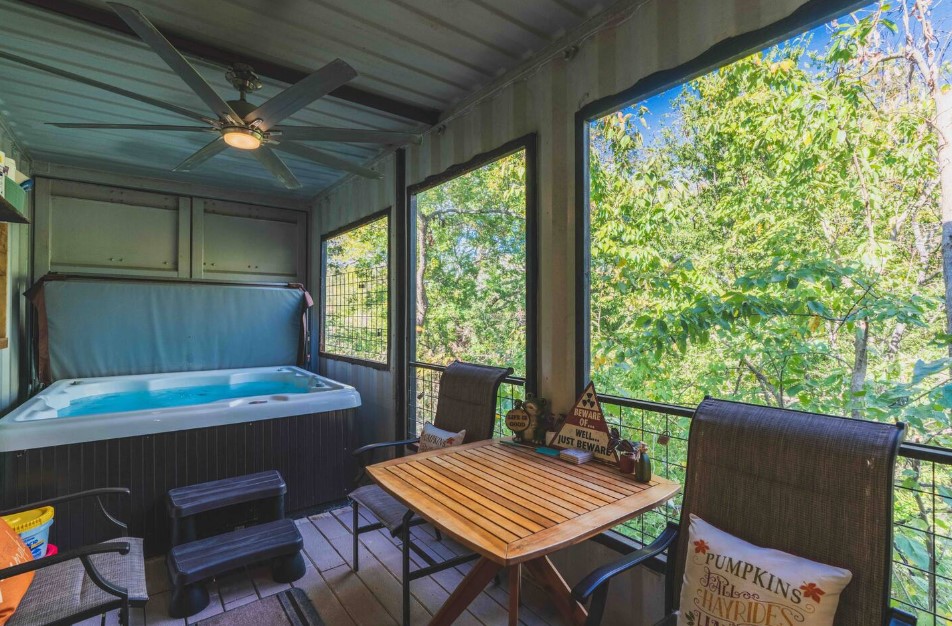 hot tub, brown table and chairs and large windows