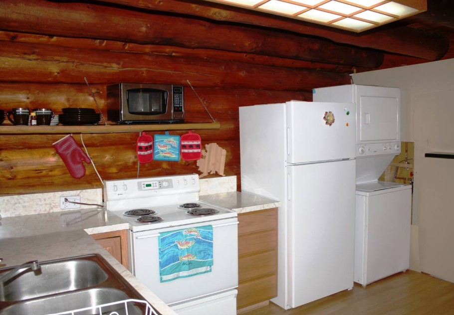 kitchen with wooden walls, wooden cabinets, open shelves, white fridge