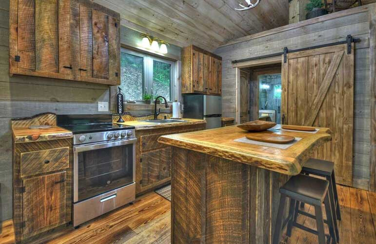 kitchen with wooden cabinets, wooden island, window above the sink