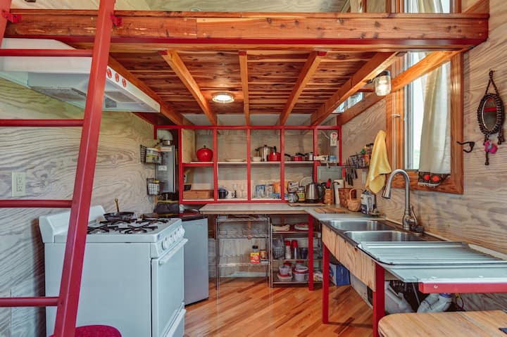 kitchen with red open shelves, wooden ceiling and flooring