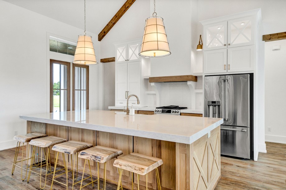 kitchen with white and brown cabinets, white countertop and five wooden stools