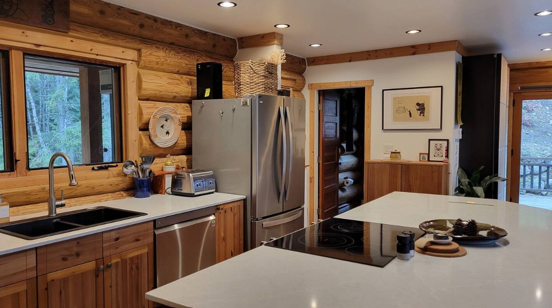 kitchen with brown cabinets, white countertops, window above the sink