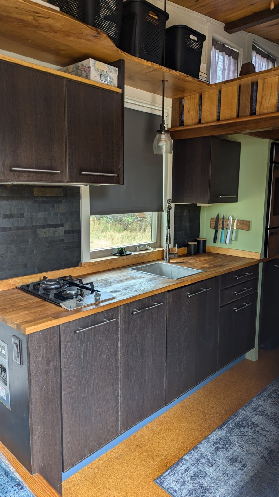 kitchen with wooden countertops, dark brown cabinets