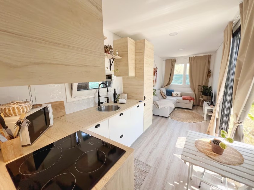 kitchen with light brown cabinets, mini dining area with a brown table