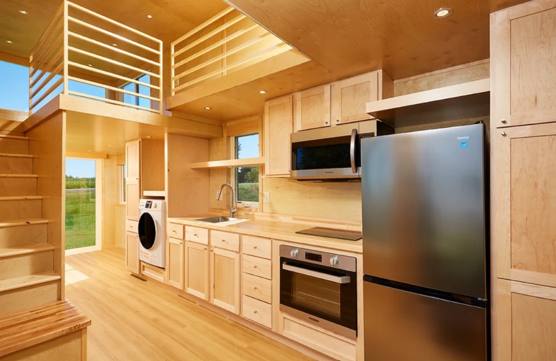 kitchen with light brown cabinets, built in oven, microwave, fridge