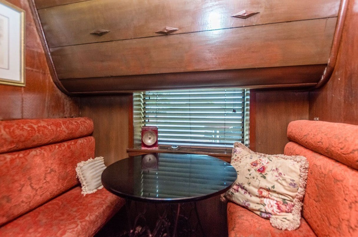 living room with two vintage sitting areas opposite each other and a black round table