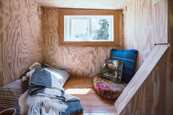 loft with wooden walls and a tiny window