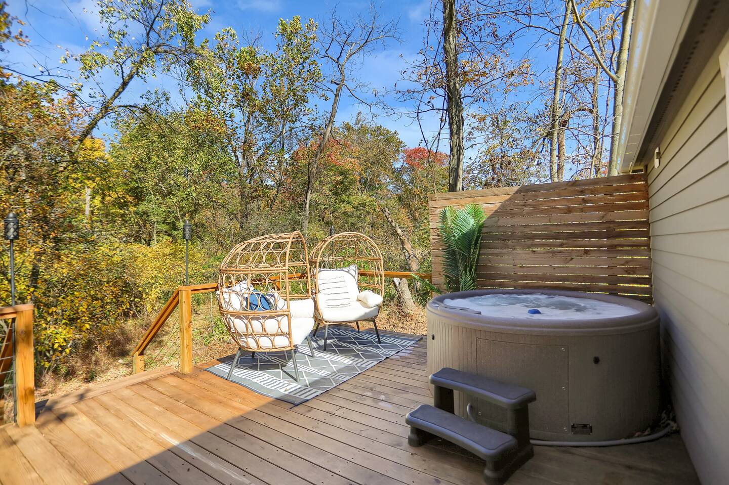 patio with two chairs and a hot tub