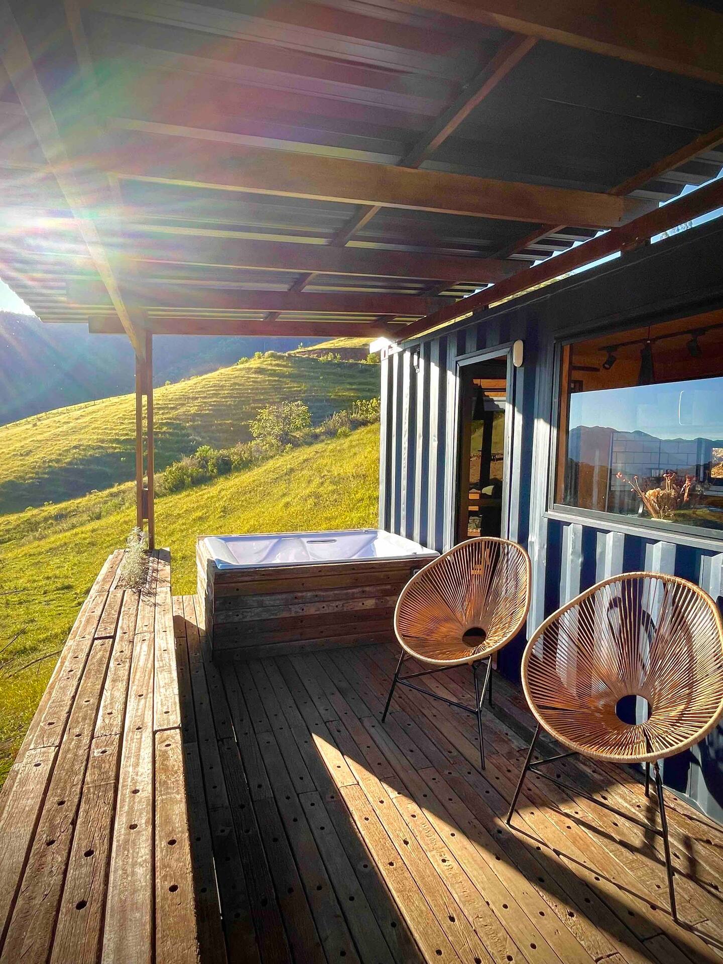 patio with a hot tub and two chairs