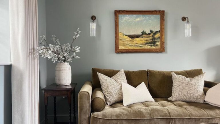 living room with a green sofa and an artwork above it