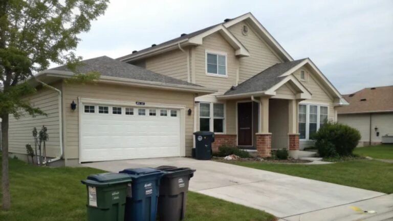 exterior of a home with trash cans in front