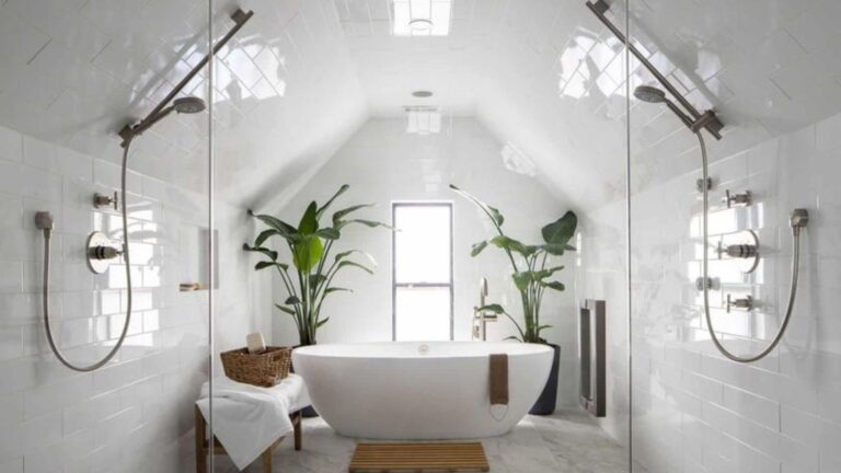 bathroom with a white bathtub, white tiles, a window and plants