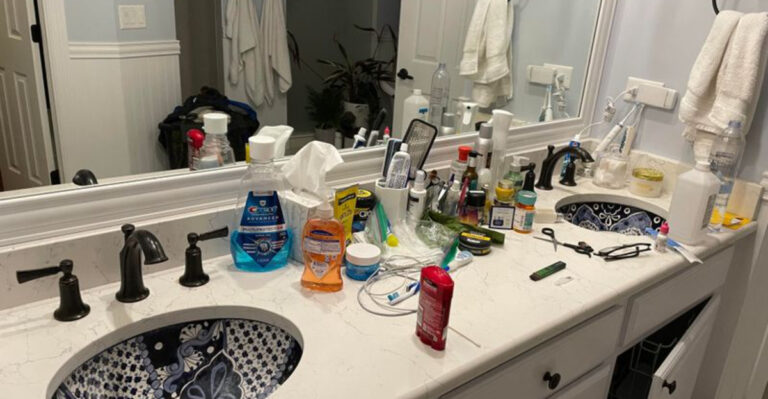 bathroom with a messy countertop