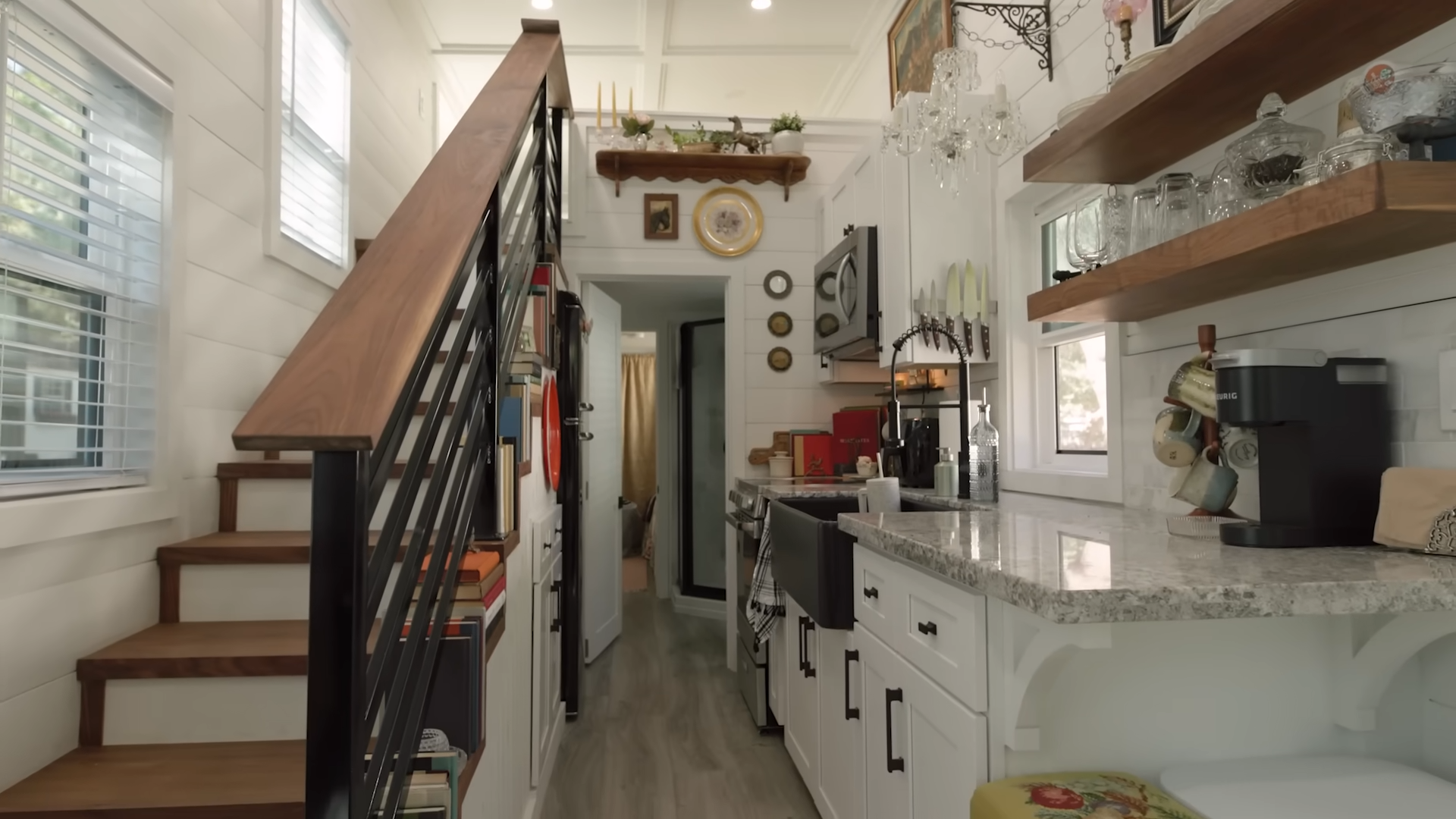 kitchen with white cabinets and granite countertops on the right, stairs on the left