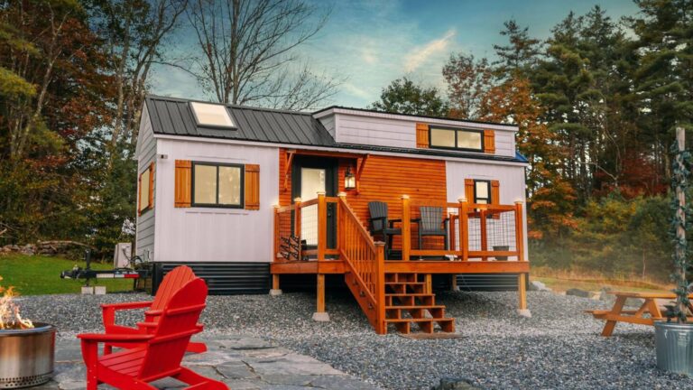 exterior of a tiny home with a fire pit in front
