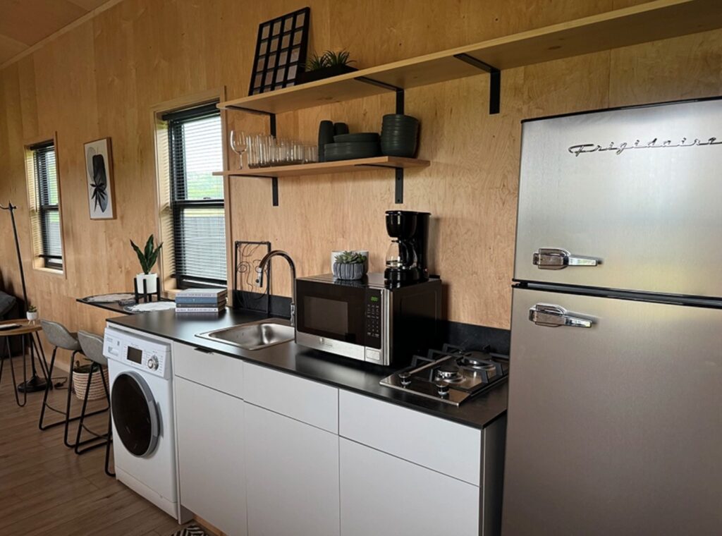 Modern tiny kitchen with a full-sized fridge