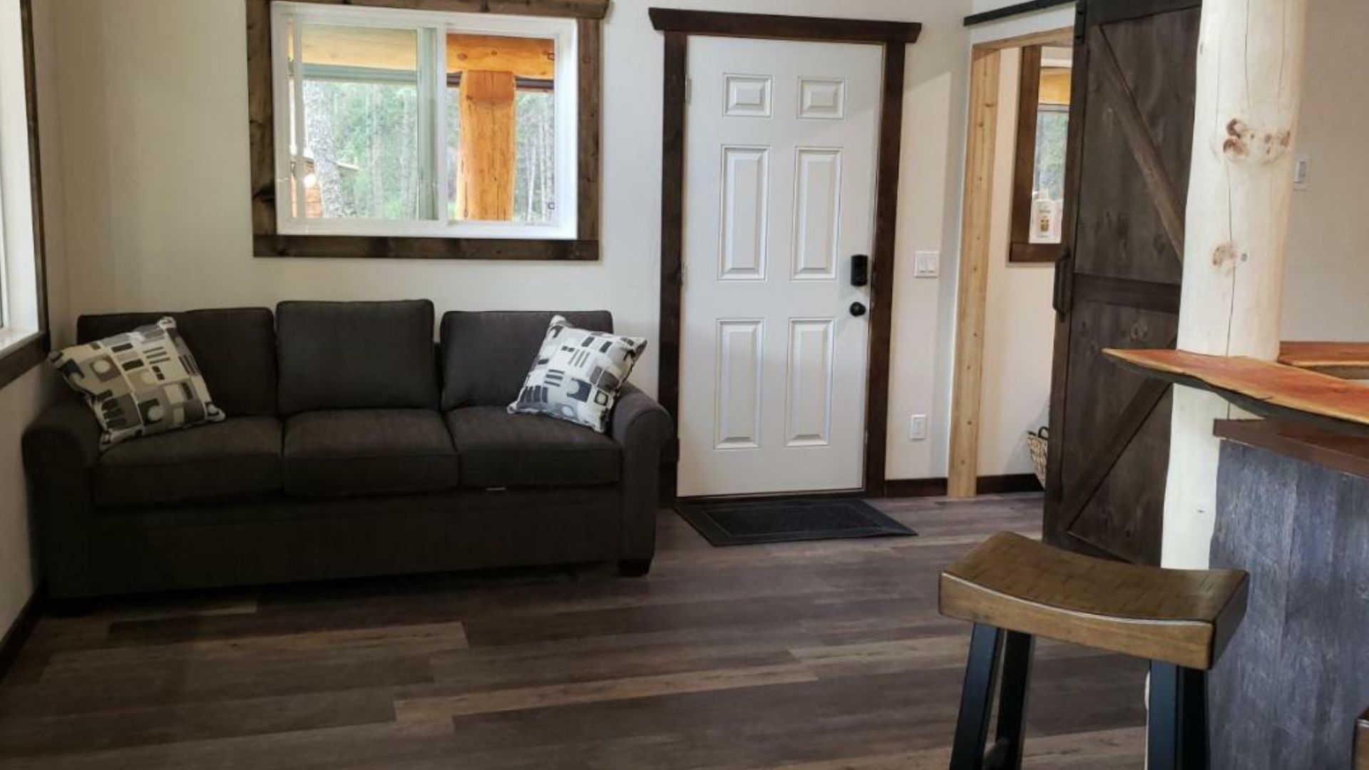 dark wood living room with a grey sofa