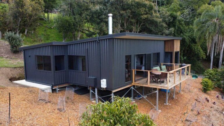 exterior of a container home surrounded by greenery