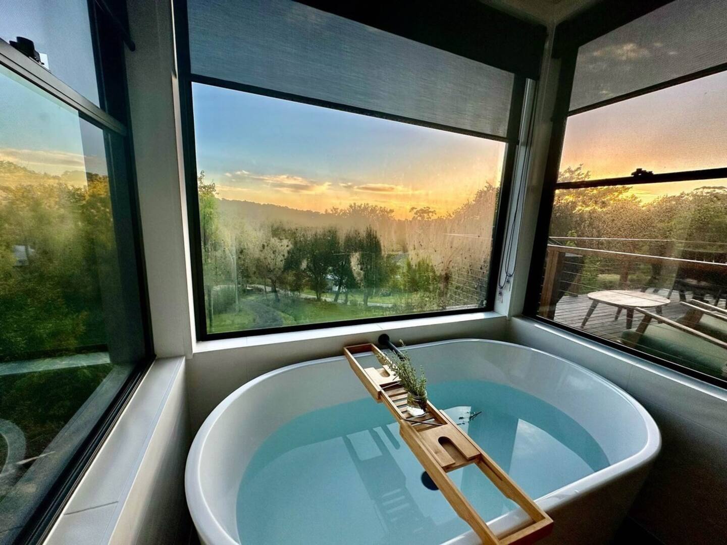 bathroom with a big bathtub with windows all around