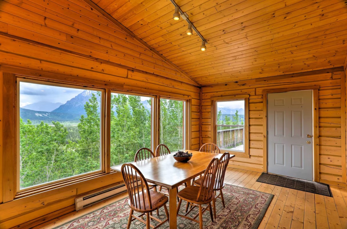 dining area with brown walls, big windows, brown dining table and brown chairs