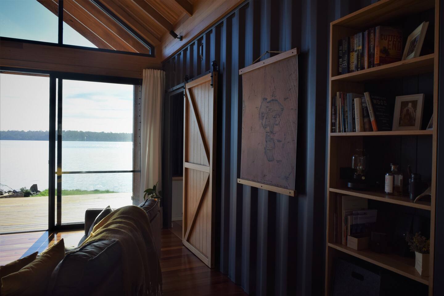 living room with floor to ceiling windows and a bookshelf