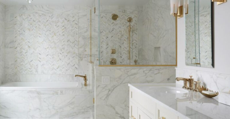 bathroom with marble tiles and golden features