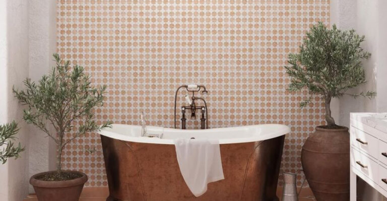 bathroom with a copper bathtub and two plants