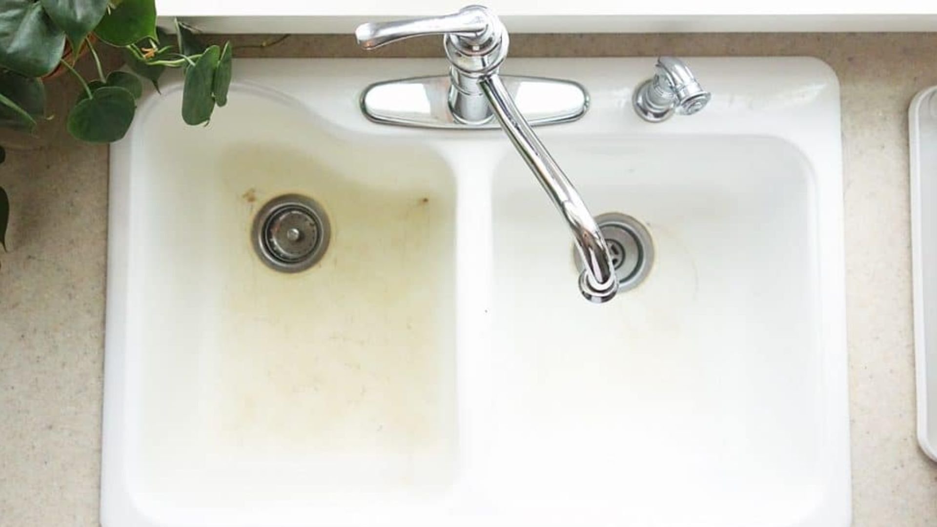 white kitchen sink stained on the left side