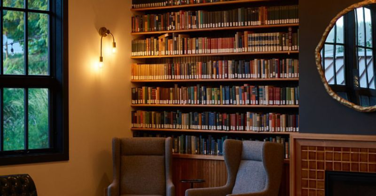 home library with two chairs and dimmed lighting