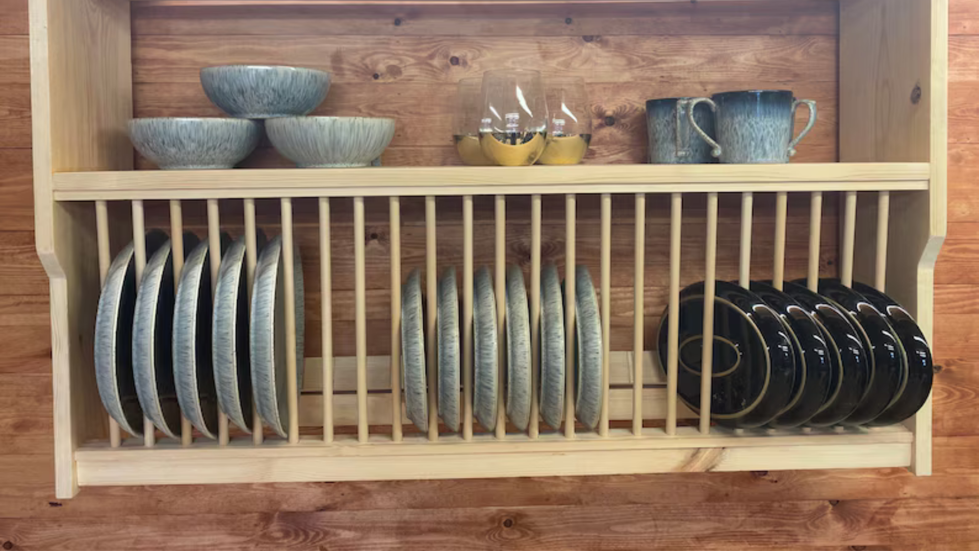plates and glasses on a wooden plate rack