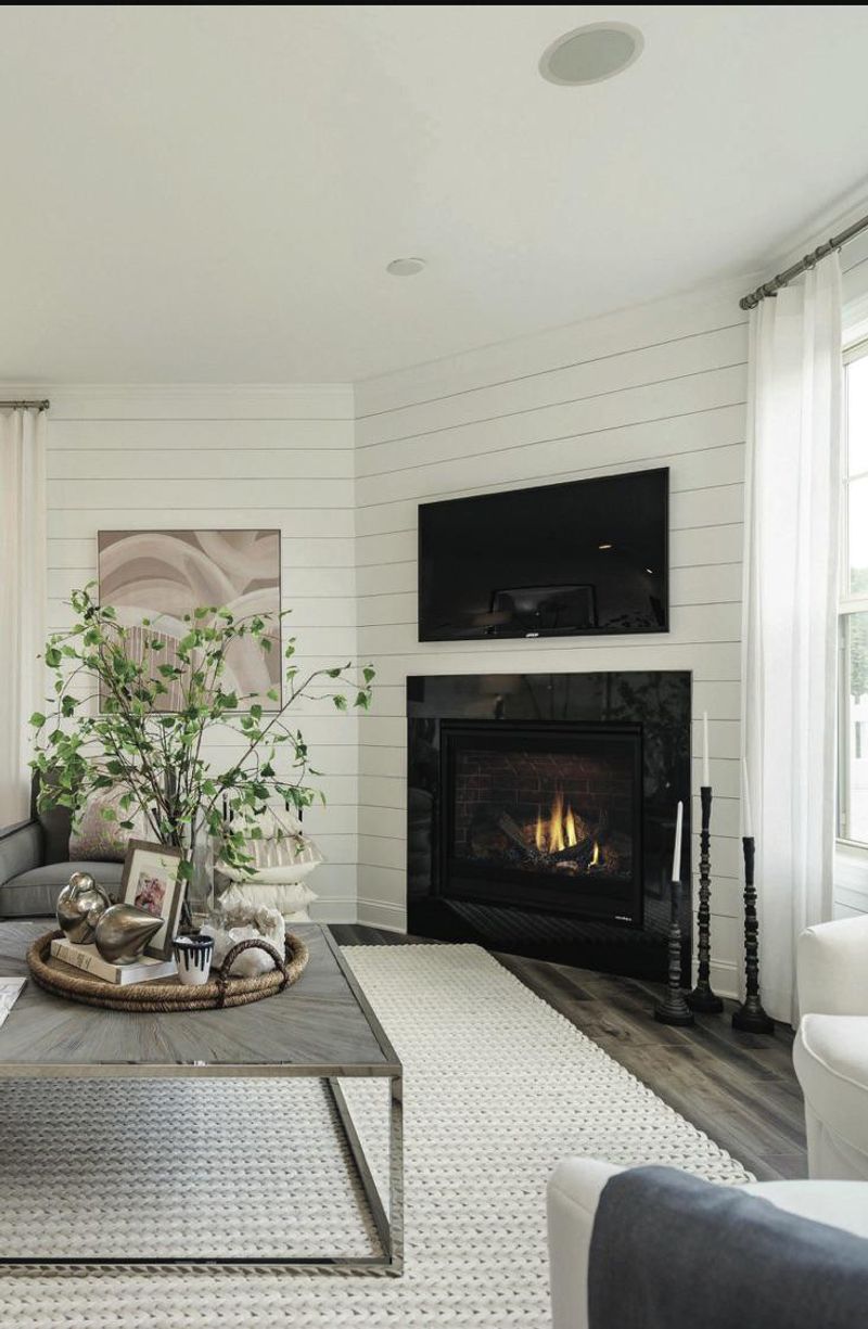 A Fireplace In The Corner Of The Living Room