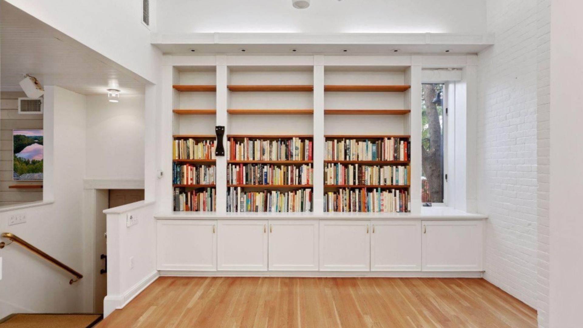 library with lots of books near the kitchen