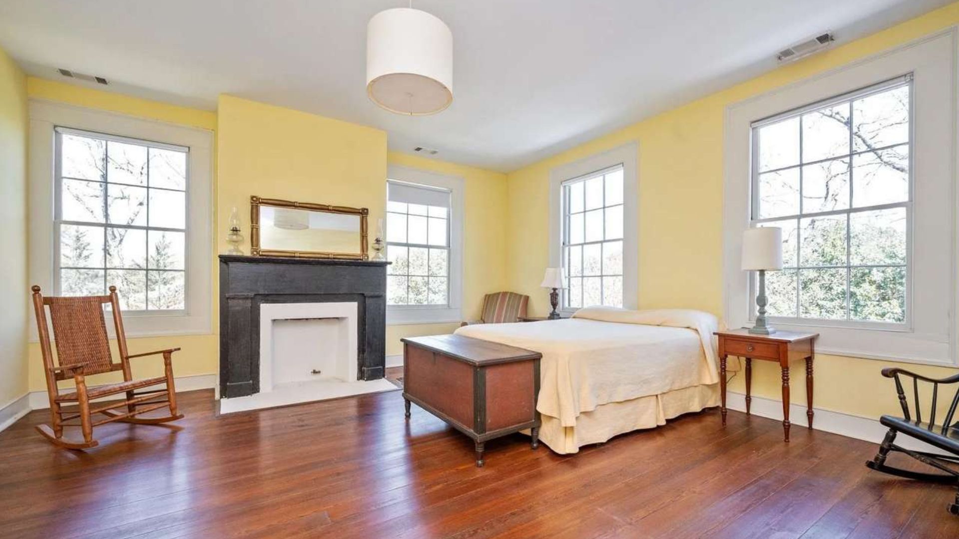 spacious bedroom with yellow walls
