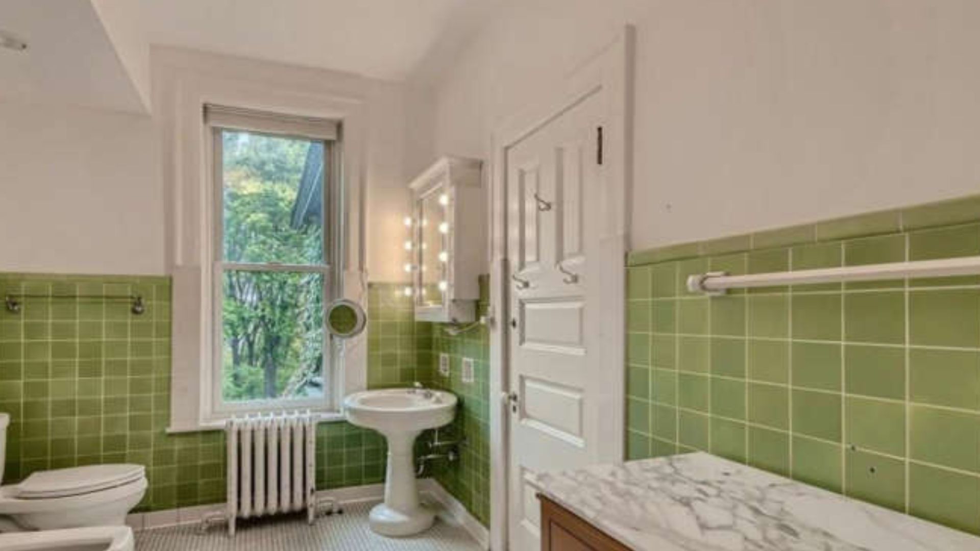 glossy tiles in green bathroom with vintage fixtures