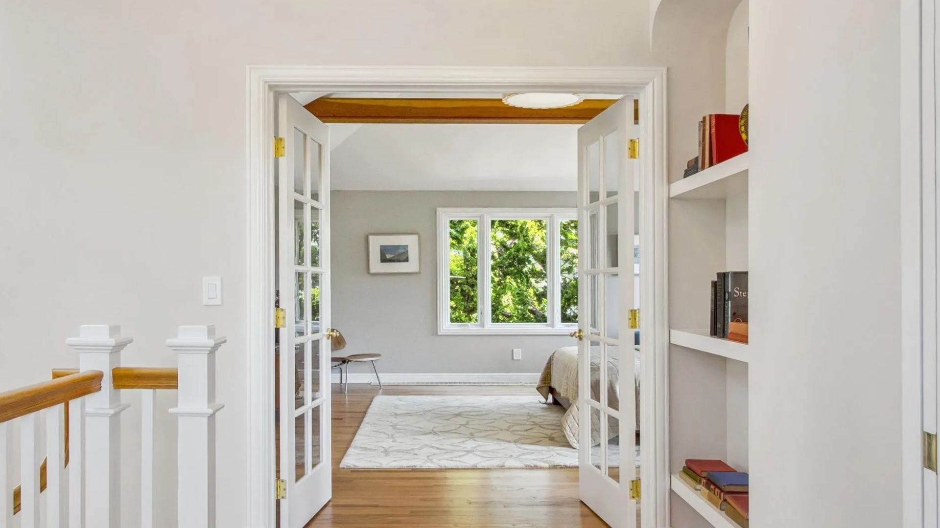 hallway with built-in bookshelves