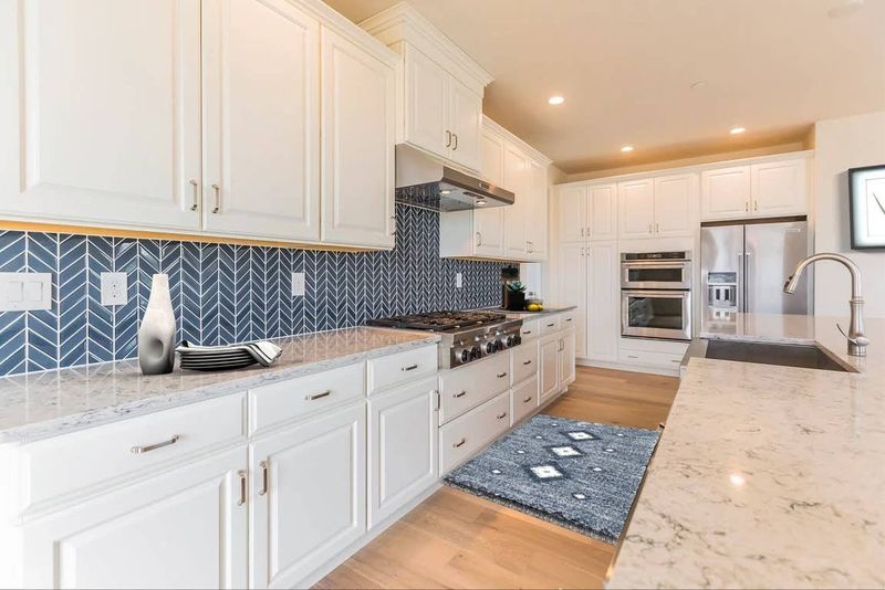 White Cabinets With Statement Backsplashes
