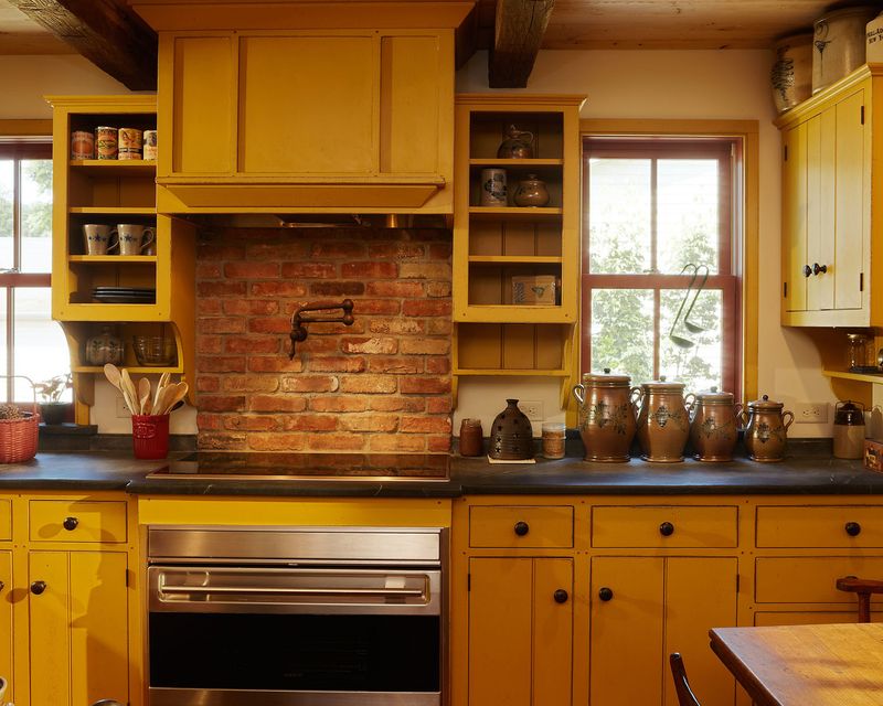 Brick with Mustard Yellow Cabinets