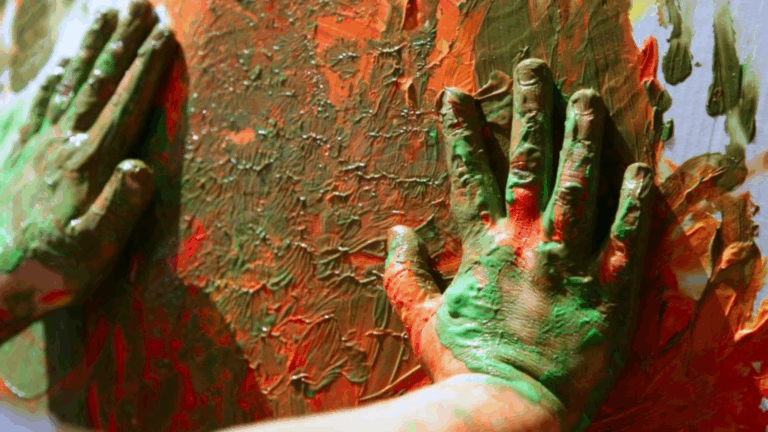 child painting with hands