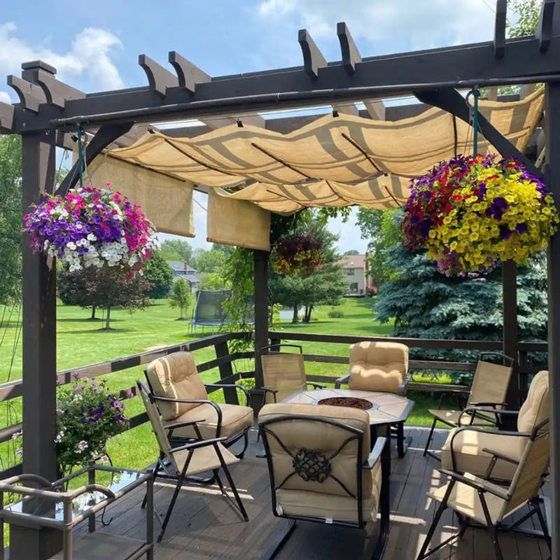 Arbor with retractable fabric canopy for shade