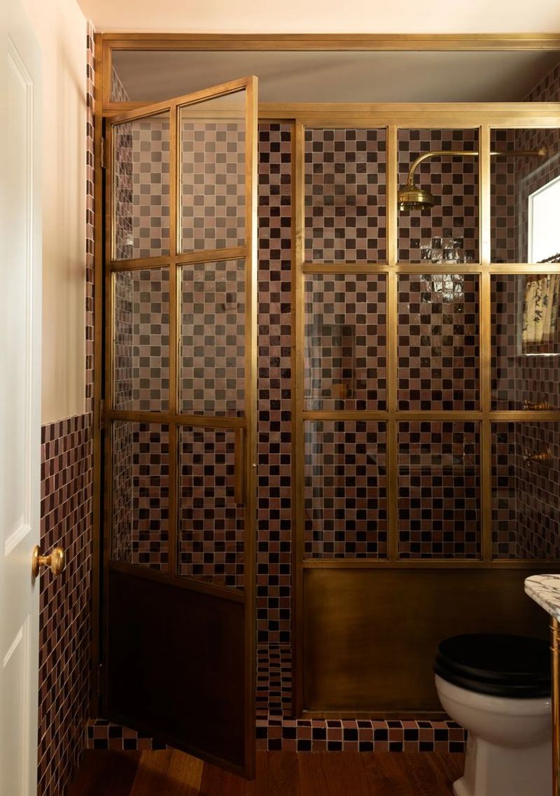 Jewel-Toned Bathroom with Brass Accents and Retro Tilework