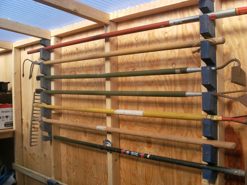 Fence-Mounted Tool Organizers For Garden Equipment