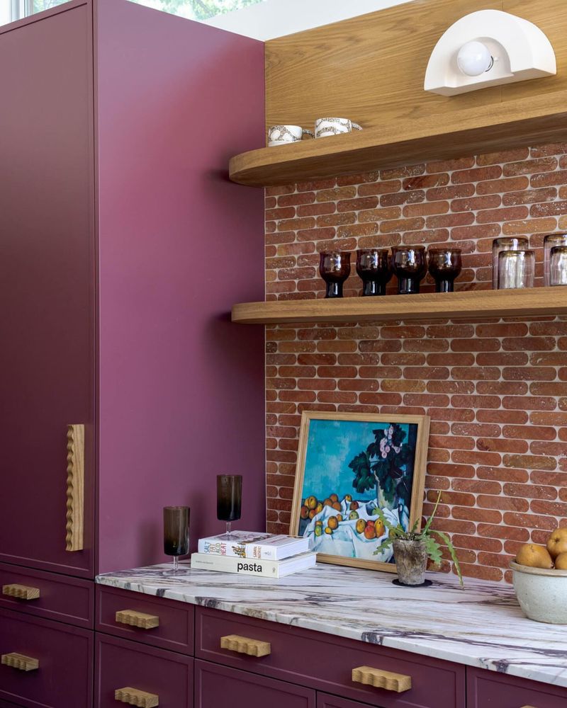 Brick Accent Wall with Plum Purple Cabinets