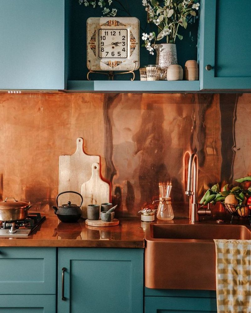 Teal Shaker Cabinets Paired with Hammered Copper Backsplash