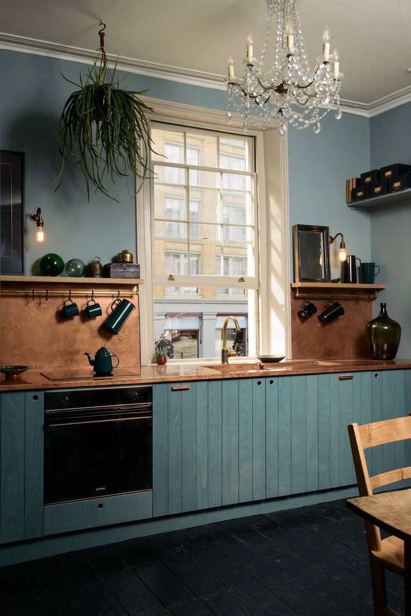 Teal and Copper Two-Tone Cabinetry in a Galley Layout